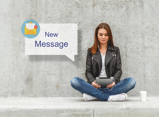 Girl with a tablet in hands reads the message