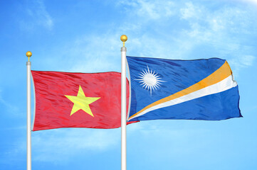 Vietnam and Marshall Islands two flags on flagpoles and blue sky