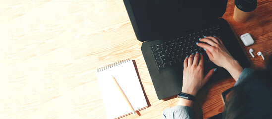 Banner with a typing girl at a laptop in the workplace.