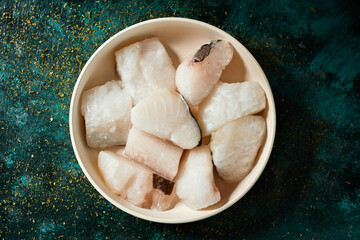 pieces of frozen uncooked codfish in a plate