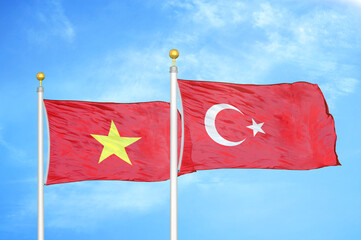 Vietnam and Turkey two flags on flagpoles and blue sky