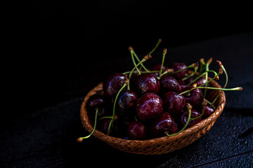 Ripe cherries on a black background