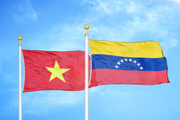 Vietnam and Venezuela two flags on flagpoles and blue sky