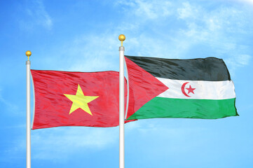 Vietnam and Western Sahara two flags on flagpoles and blue sky