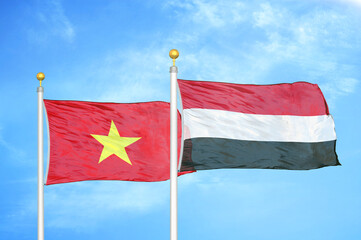 Vietnam and Yemen two flags on flagpoles and blue sky