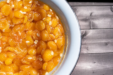 Apricot jam on wooden background