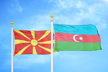 North Macedonia and Azerbaijan two flags on flagpoles and blue sky