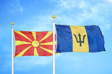 North Macedonia and Barbados two flags on flagpoles and blue sky