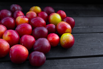 Ripe plum on wooden background