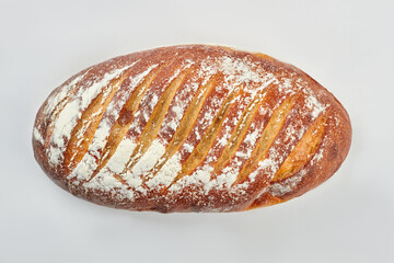 Dark bread with flour on white background. Fresh delicious homemade bread.