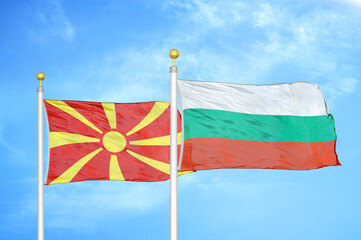 North Macedonia and Bulgaria two flags on flagpoles and blue sky