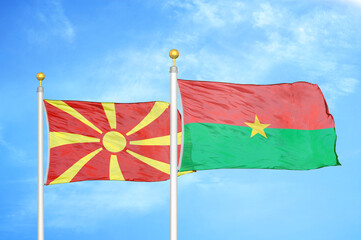North Macedonia and Burkina Faso two flags on flagpoles and blue sky
