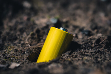 battery in the soil. soil pollution and poisoning concept.