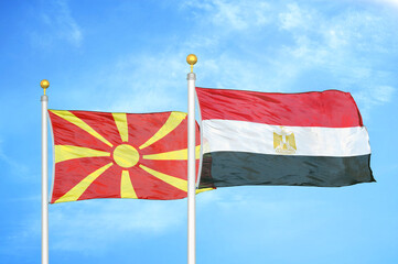North Macedonia and Egypt two flags on flagpoles and blue sky