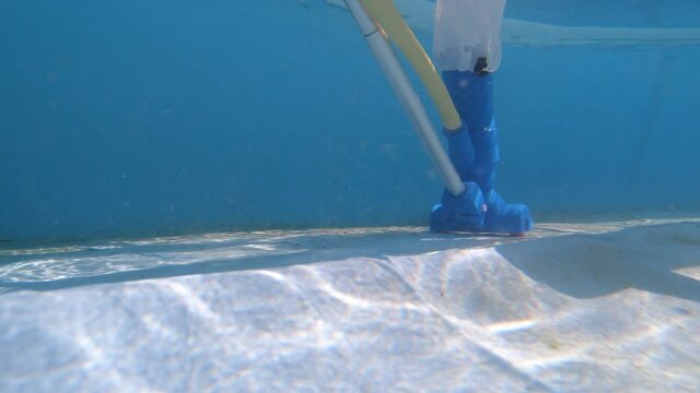 Underwater view of a pool vacuum cleaner on a pool floor