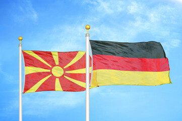 North Macedonia and Germany two flags on flagpoles and blue sky