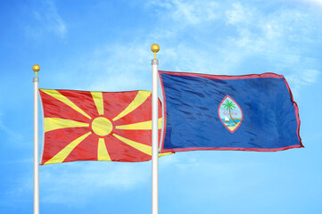 North Macedonia and Guam two flags on flagpoles and blue sky