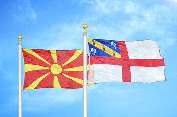 North Macedonia and Herm two flags on flagpoles and blue sky