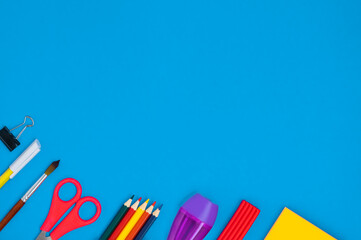 Office supplies on a blue background. Back to school concept. Display of products for creativity and learning. School supplies. Layout of the school. Flatlay. copy space.