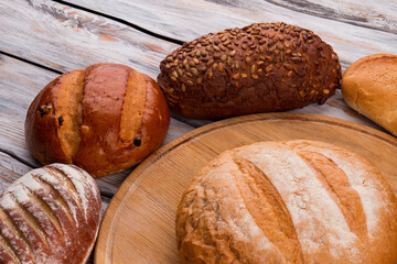 Whole wheat bread on wooden background. Various types of organic bread.