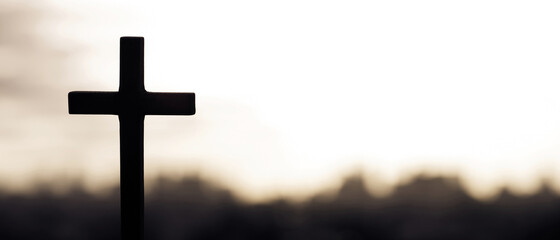 Silhouette cross against the sky At Sunset. Dramatic nature background. Crucifixion Of Jesus...