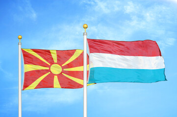 North Macedonia and Luxembourg two flags on flagpoles and blue sky