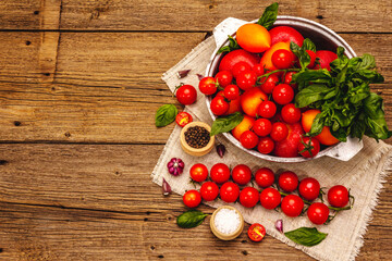 Assorted ripe multicolored tomatoes. Young garlic, fresh basil leaves, salt, spices