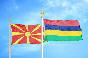North Macedonia and Mauritius two flags on flagpoles and blue sky