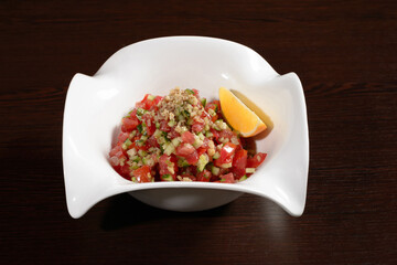 Healthy salad for a healthy diet from tomatoes, cucumbers with olive oil and walnuts. Photos for restaurant and cafe menus