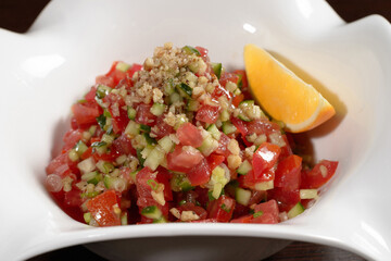 Vegetarian vegetable salad with tomatoes and cucumbers seasoned with olive oil, close up. Photos for restaurant and cafe menus