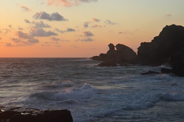 Fototapeta na wymiar Sunset at beach with window rock formation