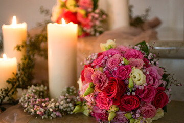 brides flower bouquet next to a candle in a church