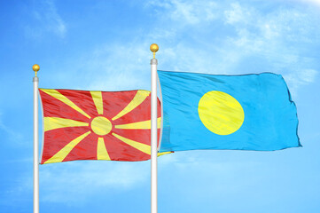 North Macedonia and Palau two flags on flagpoles and blue sky