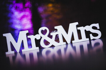 mr & mrs sign on reflecting table with stylish background color