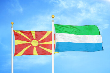 North Macedonia and Sierra Leone two flags on flagpoles and blue sky