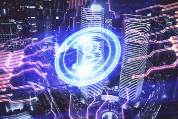 Multi exposure of cryptocurrency theme hologram drawing and city veiw background. Concept of blockchain and bitcoin.