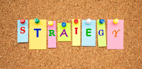 Multicolor notes with letters pinned on a cork notice board.