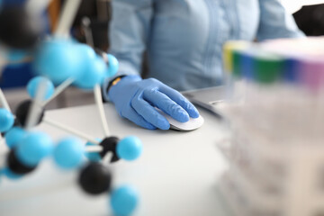 Workplace scientist with gloves working on laptop. Scientific research and development of new drugs concept