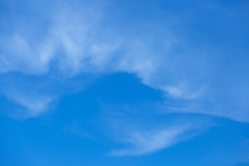 Blue sky background with tiny clouds.