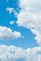 Obraz na płótnie Canvas Blue sky with white clouds. Vertical shot.