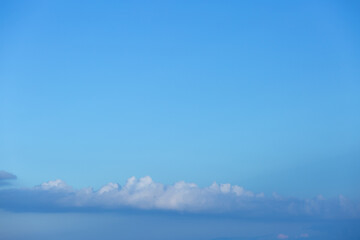 Naklejka na ściany i meble Blue sky background with tiny clouds.