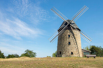Fototapeta na wymiar old stone windmill in the countryside near Weddersleben, Germany
