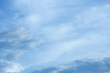 Blue sky background with tiny clouds.