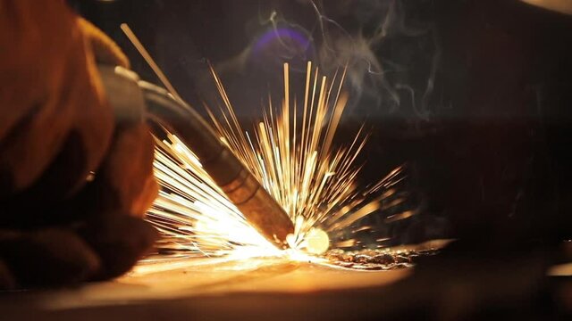 Closeup of a welding machine in work. Worker welds metal. High quality HD footage