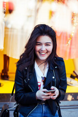 young pretty asian woman outside on big city street, lifestyle people concept