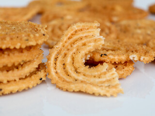 Nurukku or murukku a traditional Kerala snack made of rice powder in white background, isolated ,  selective focus