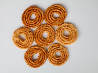 Nurukku or murukku a traditional Kerala snack made of rice powder in white background, isolated