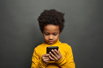 Little black child using smartphone