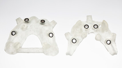 two dental templates for implantation of the upper and lower jaw, filmed on a white background