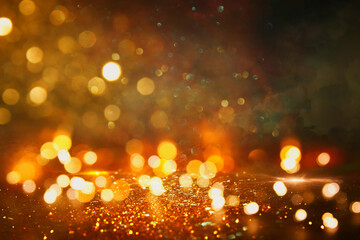 background of abstract gold and black glitter lights. defocused